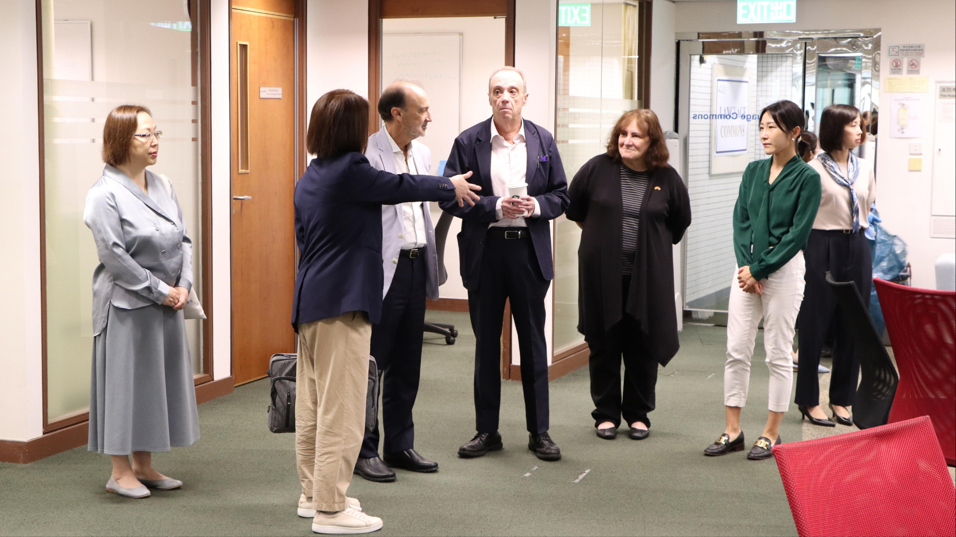 CLE representatives showing the guests around the Language Commons and the CLE AI Lab